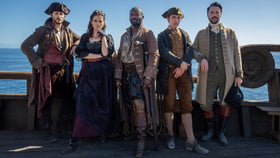 Treasure Island 2026 cast posed on the deck of a sailing ship