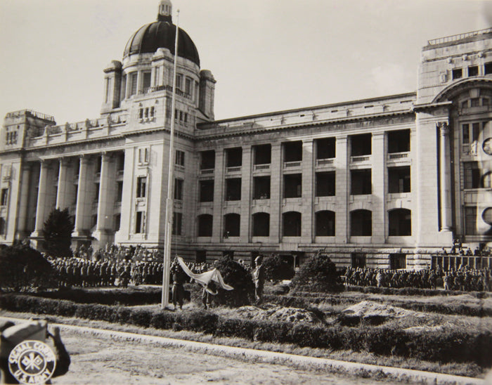 Archival photograph of the Japanese flag being lowered at the former Government-General building in Seoul in 1945