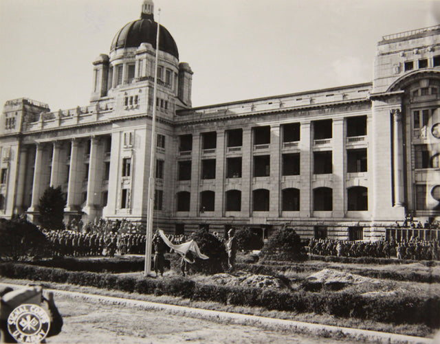 Archival photograph of the Japanese flag being lowered at the former Government-General building in Seoul in 1945