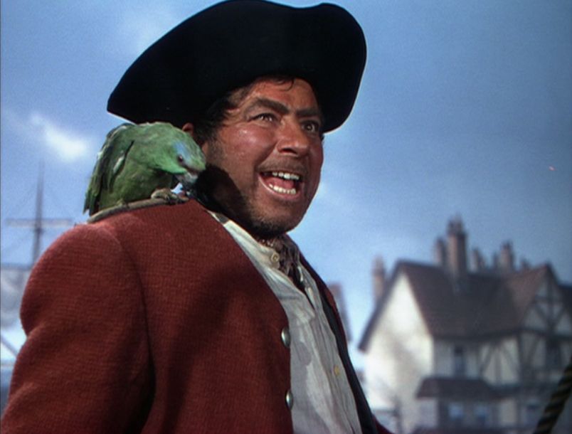 Robert Newton as Long John Silver with his parrot in Disney's Treasure Island (1950)