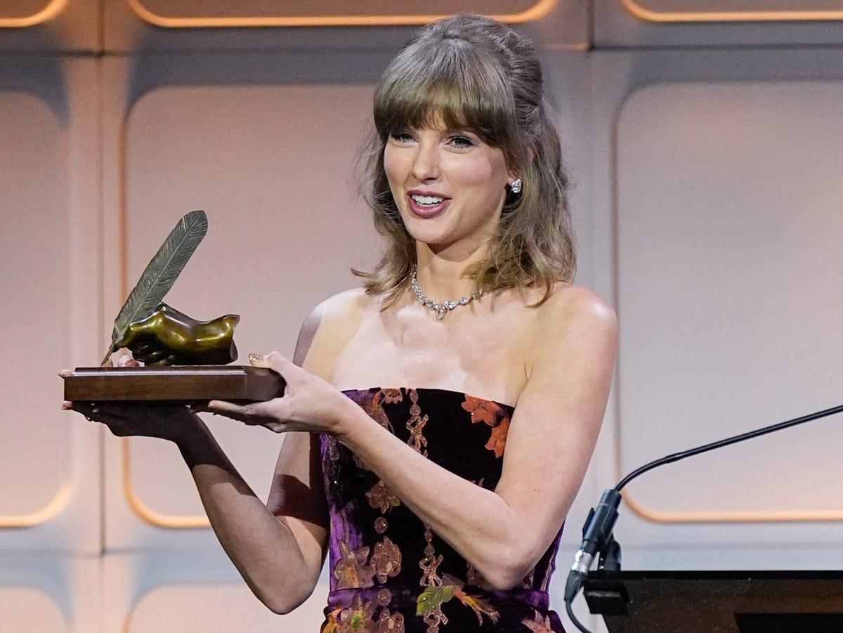 Taylor Swift in burgundy velvet floral minidress Nashville Songwriters Hall of Fame 2026