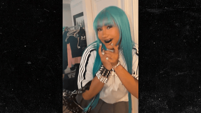 North West showing blue hair and black grills in a TikTok fashion look