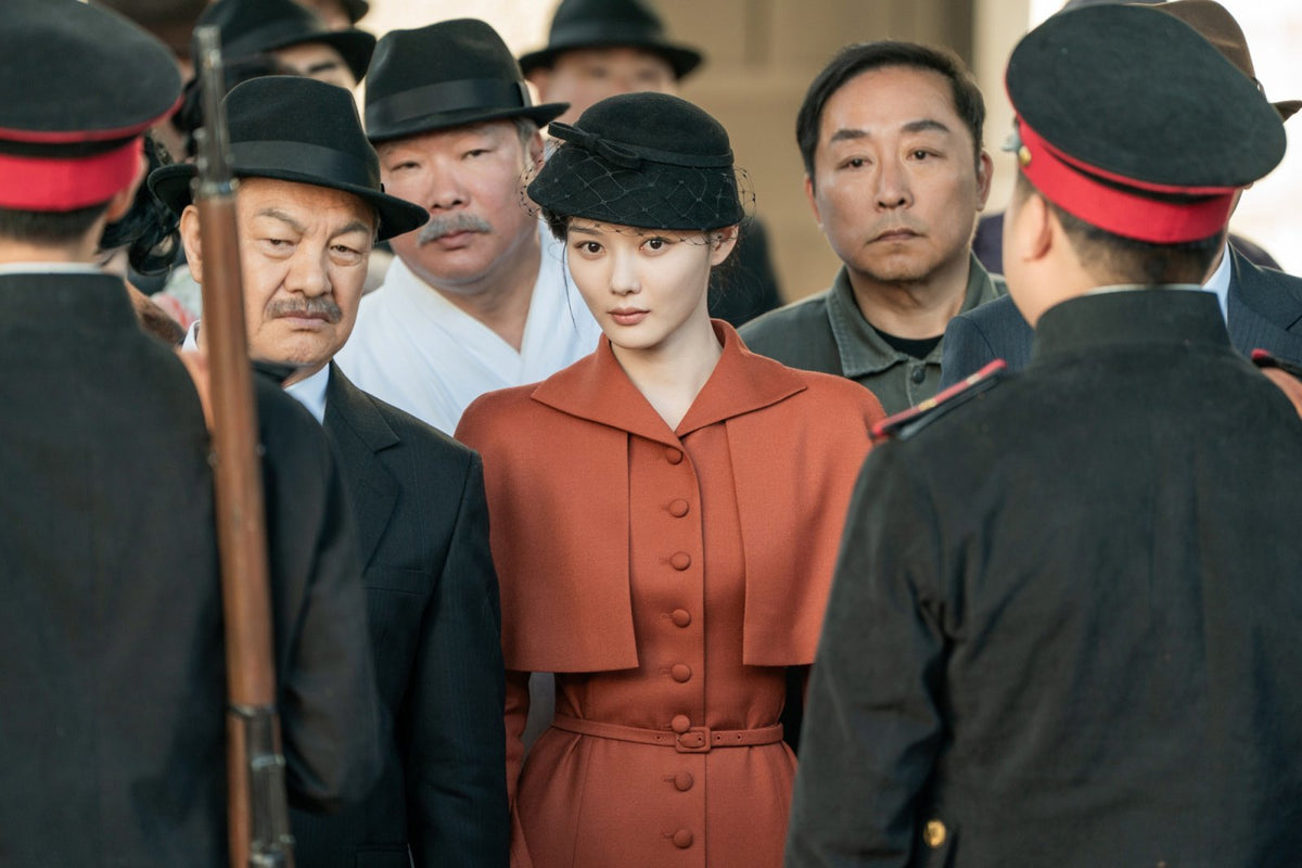 Kim You-jung in a rust-colored coat in a 100 Days of Deception promotional still