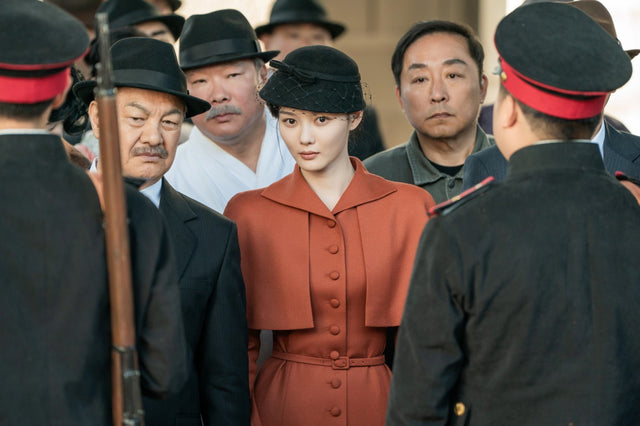 Kim You-jung in a rust-colored coat in a 100 Days of Deception promotional still
