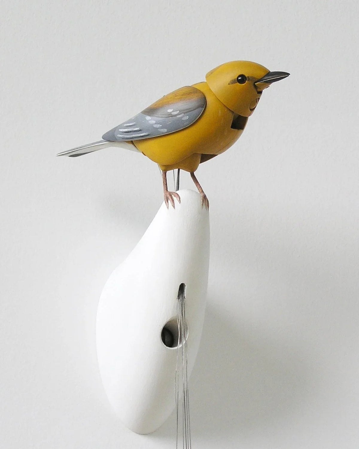 Close-up of the handcrafted yellow mechanical bird created by Bliss Kolb