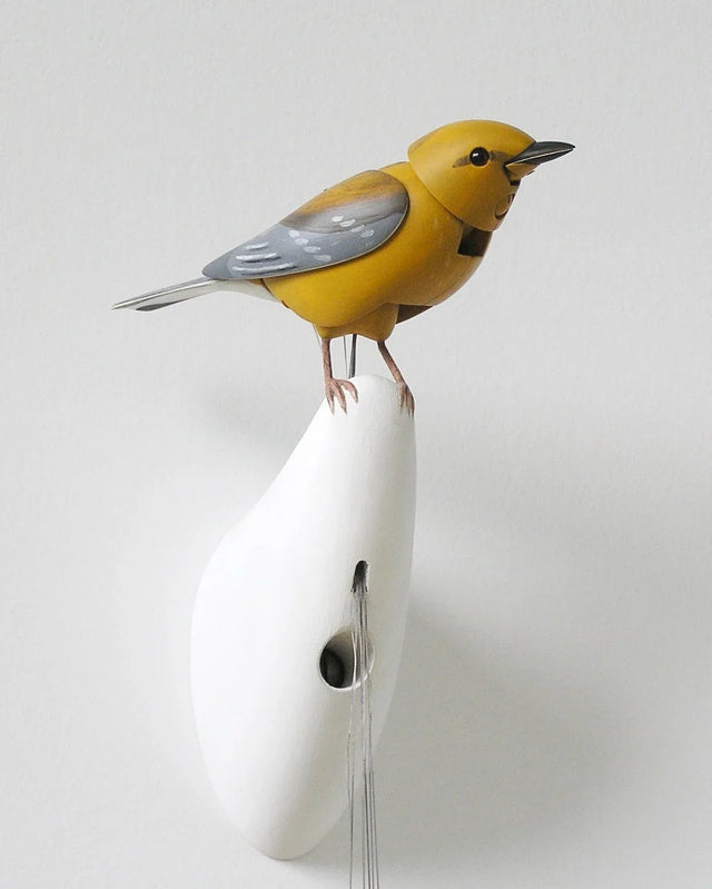 Close-up of the handcrafted yellow mechanical bird created by Bliss Kolb