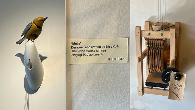 Molly the mechanical singing bird beside the $15 million price sign at Art of Play in Brooklyn