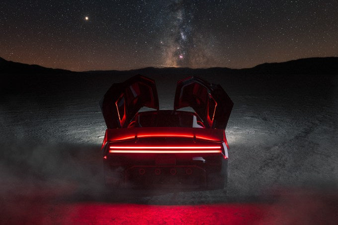 Rear view of the next-generation Tesla Roadster with its doors open under a night sky