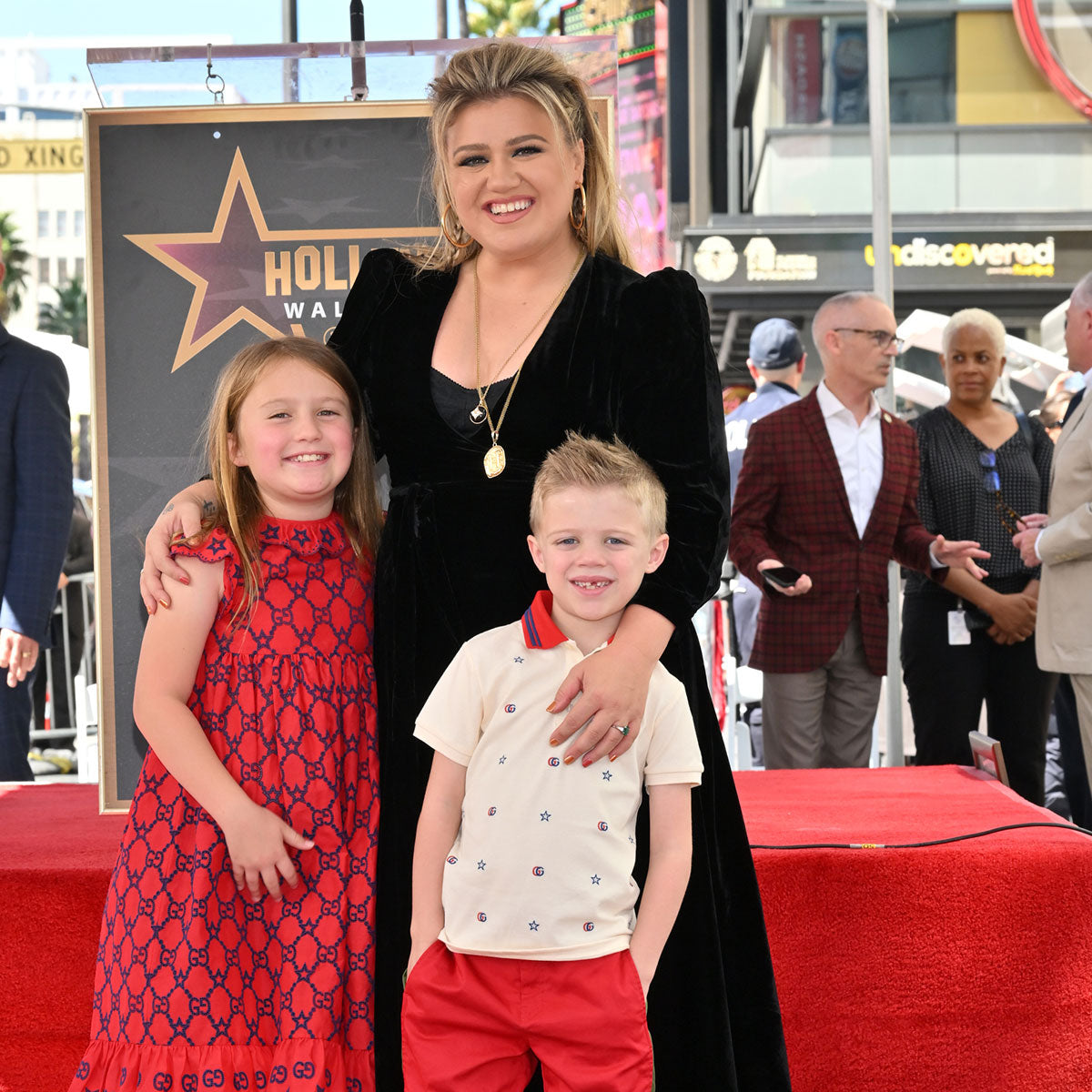 Kelly Clarkson with her two children at a public Hollywood Walk of Fame celebration in 2023
