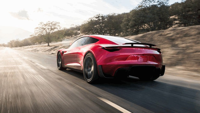 Red Tesla Roadster concept photographed from the rear three-quarter angle